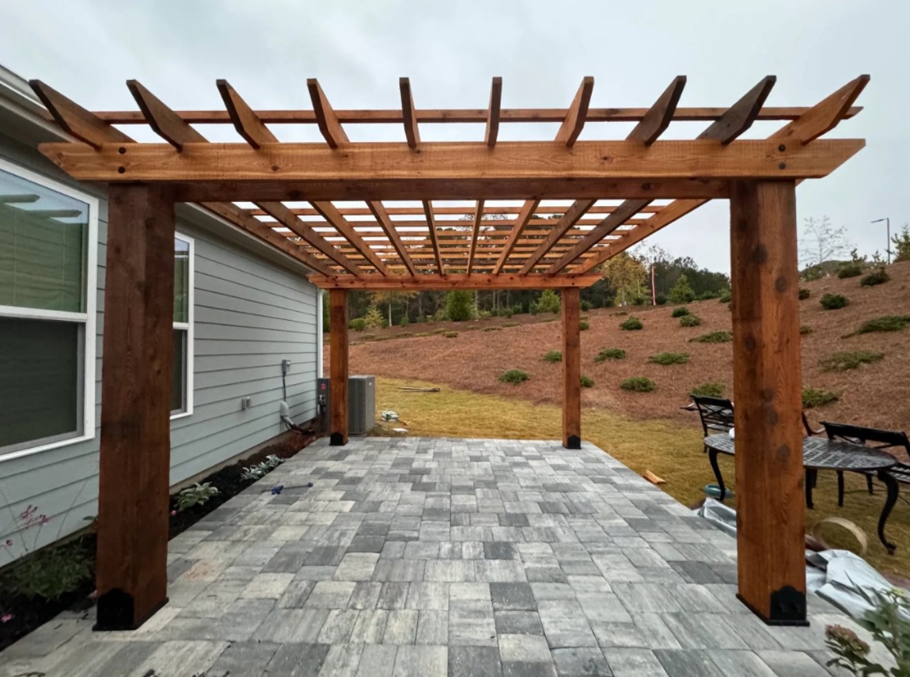 Cedar pergola over a new paver patio