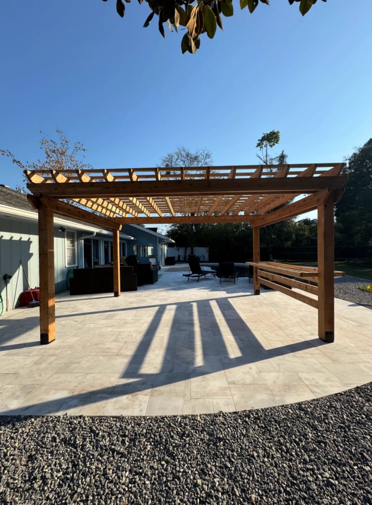 Pergola with bar ledge on a travertine patio